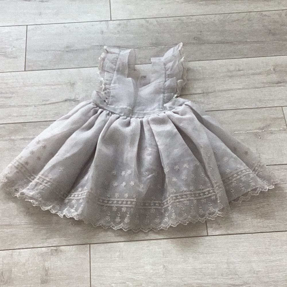 Noralee dress with flower designs on the bottom. Button down back with lace.